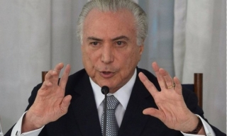 A revogação foi publicada enquanto o presidente Temer estava reunido no Palácio do Planalto (Foto: AFP) A revogação foi publicada enquanto o presidente Temer estava reunido no Palácio do Planalto (Foto: AFP)